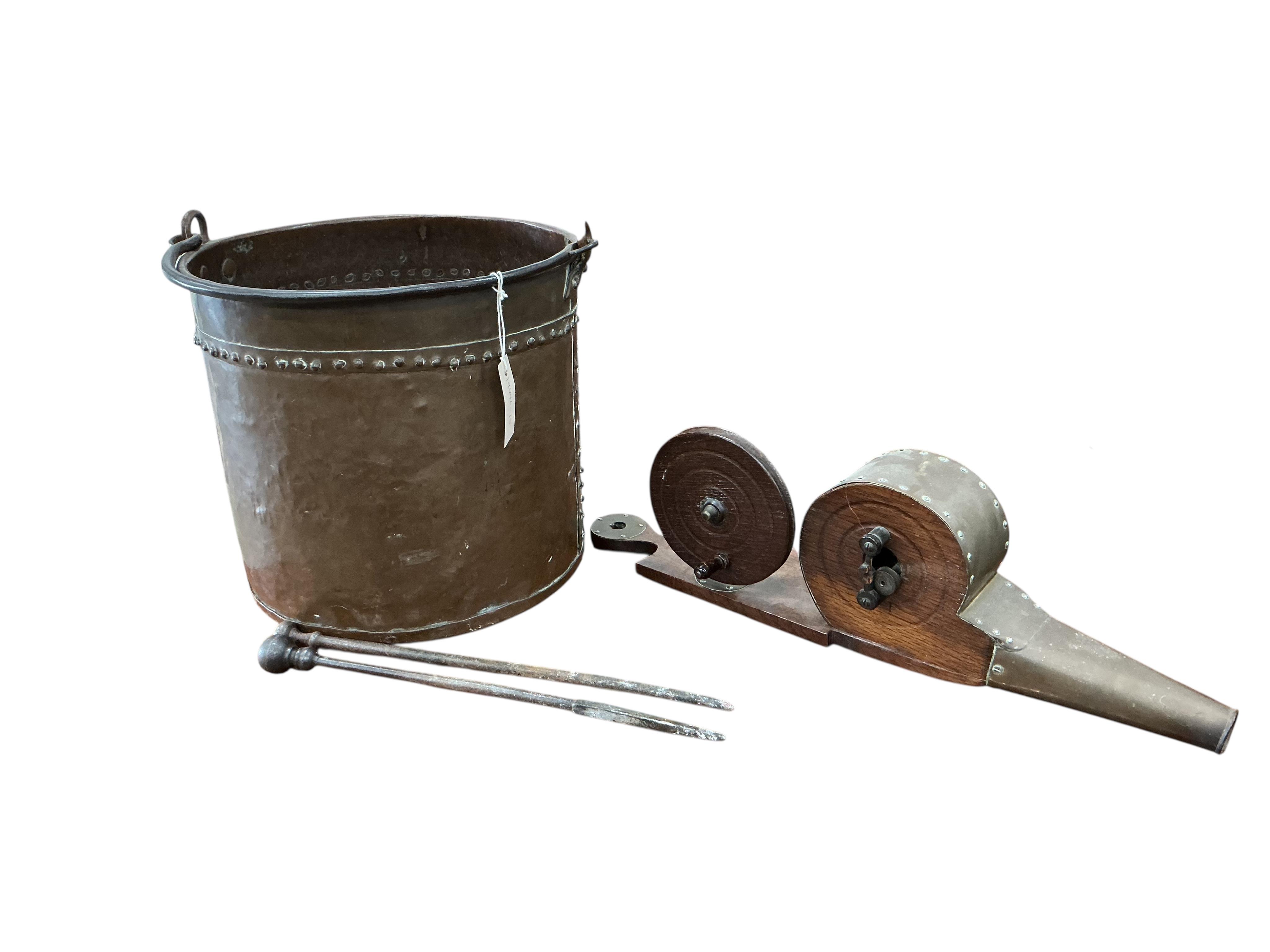 A Victorian brass mounted oak fire bellows, a circular copper log bin and assorted implements
